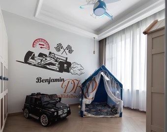 May include: A blue and white play tent with a white mesh curtain, a black toy car, and a white wall with a black race car decal and the text "Benjamin DK Dream Kids Decor".
