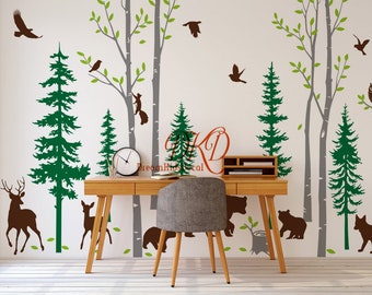 May include: A wall decal featuring a forest scene with trees, animals, and birds. The design includes green pine trees, brown deer, bears, and a fox, with gray tree trunks and branches. The text "DreamKidsDecal" is visible.