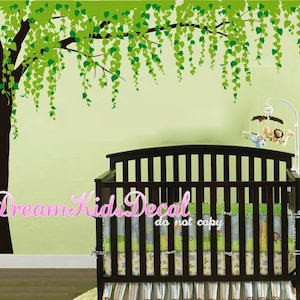 May include: A green and brown weeping willow tree wall decal with a crib in the foreground. The decal is perfect for a nursery or child's room. The text "Dream Kids Decal do not copy" is visible in the image.