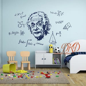 May include: A light blue wall mural featuring a dark blue illustration of Albert Einstein's face, surrounded by mathematical formulas. The room includes a white bed, a white cabinet, two wooden chairs, and toys scattered on the floor.