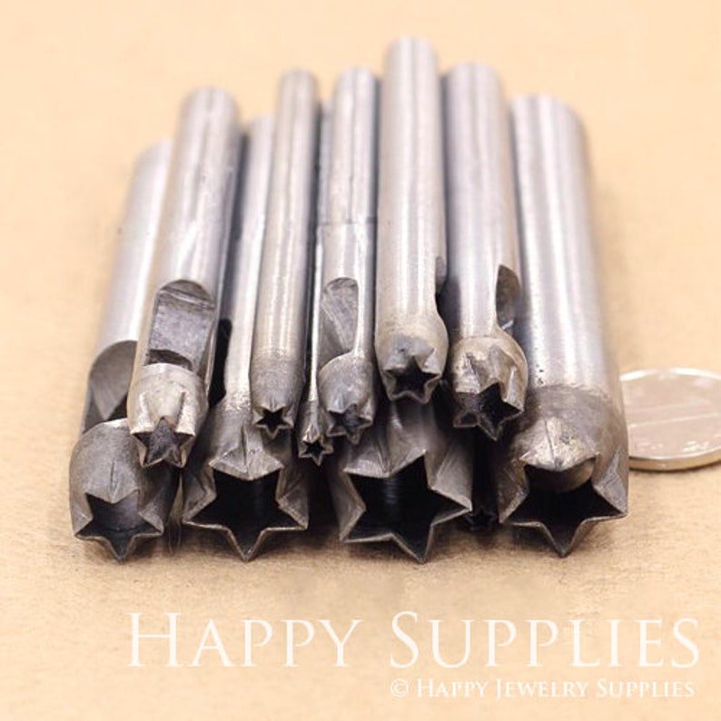 May include: A set of 12 metal star-shaped punches for leather crafting. The punches are arranged in a row, with the largest punch on the left and the smallest punch on the right.