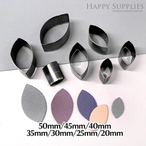 May include: Set of 7 metal leaf-shaped leather craft punches in various sizes: 50mm, 45mm, 40mm, 35mm, 30mm, 25mm, and 20mm. The punches are arranged on a gray surface with leather samples cut out using the punches.