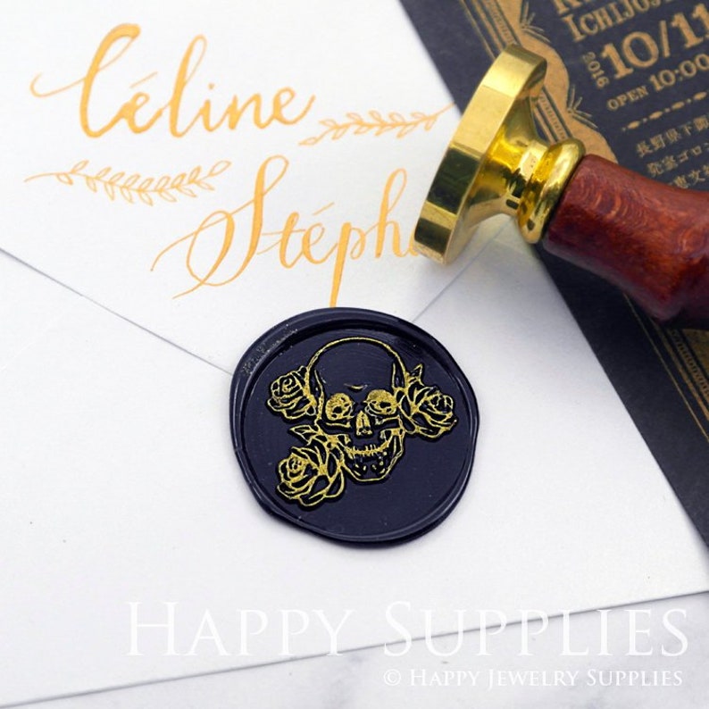A black round wax seal on the envelope. A wax stamp above the seal.In the seal, 2 roses at the skull's left side, one connect the mouth  and another connect the head. A rose touch the skull's right eye. The skull and rose are painted in gold.