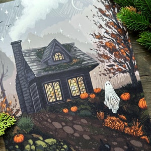 May include: A print depicting a Halloween scene. A dark grey house with lit windows and a chimney is surrounded by pumpkins and a ghost. The sky is grey and white with stars and a crescent moon.