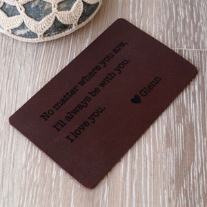 May include: A brown leather card with the text "No matter where you are, I'll always be with you. I love you." and the name "Glenn" engraved on it.