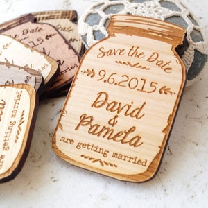 May include: Wooden save the date magnets shaped like mason jars with the text "Save the Date 9.6.2015 David & Pamela are getting married"