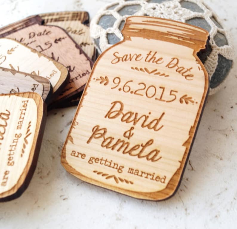 May include: Wooden save the date magnets shaped like mason jars with the text "Save the Date 9.6.2015 David & Pamela are getting married"