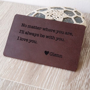 May include: A brown leather wallet with the text "No matter where you are, I'll always be with you. I love you. Glenn" engraved on it.