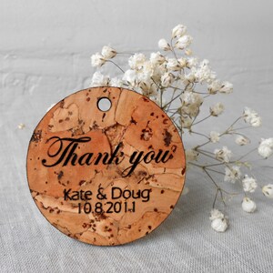 May include: Round cork tag with the text "Thank you" and "Kate & Doug 10.8.2011" in black lettering.