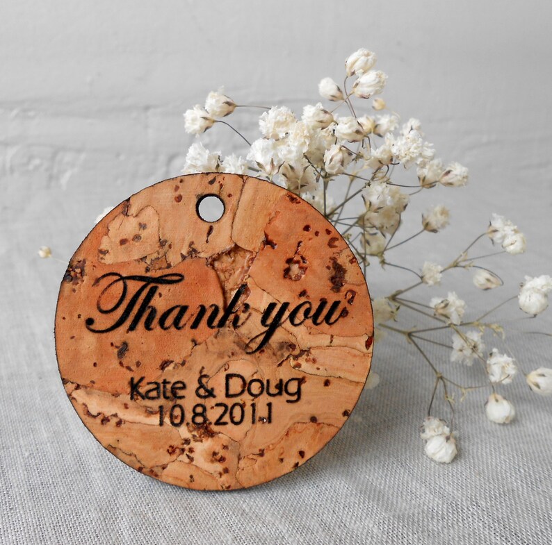 May include: Round cork tag with the text "Thank you" and "Kate & Doug 10.8.2011" in black lettering.