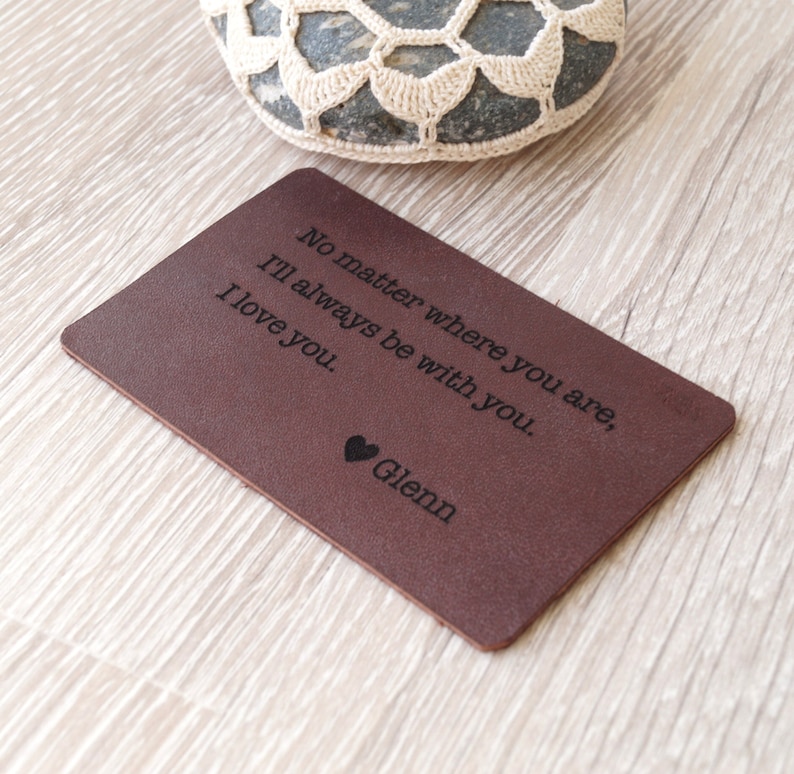 May include: A brown leather wallet card with the text "No matter where you are, I'll always be with you. I love you. Glenn" engraved on it.
