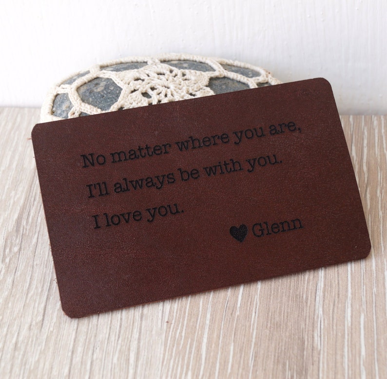 May include: A brown leather wallet with the text "No matter where you are, I'll always be with you. I love you. Glenn" engraved on it.