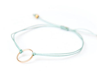 Delicate gold ring bracelet on a nylon thread handmade in Montreal