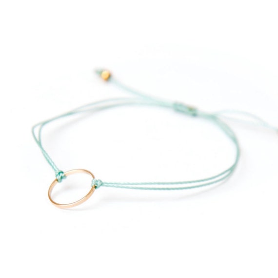 Delicate gold ring bracelet on a nylon thread handmade in Montreal