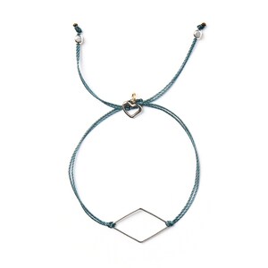 May include: A teal blue friendship bracelet with a silver heart charm and a silver diamond-shaped charm.