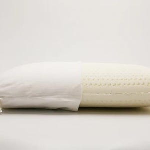 May include: A white pillow with a removable cover. The pillow is made of a breathable, open-cell foam with a textured surface. The cover is made of a soft, white fabric.