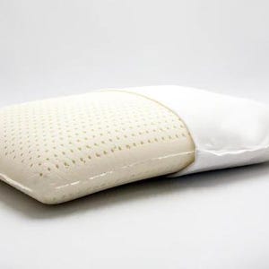 May include: A white latex pillow with a breathable, perforated surface and a removable white cotton cover. The pillow is designed for comfortable sleep and support.