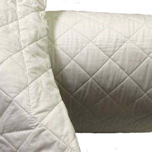 May include: A white quilted pillow cover with a diamond pattern. The pillow cover is made of soft, breathable fabric and is perfect for adding a touch of elegance to any bedroom.