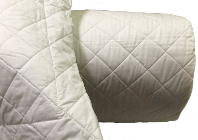 May include: A white quilted pillow cover with a diamond pattern. The pillow cover is made of soft, breathable fabric and is perfect for adding a touch of elegance to any bedroom.