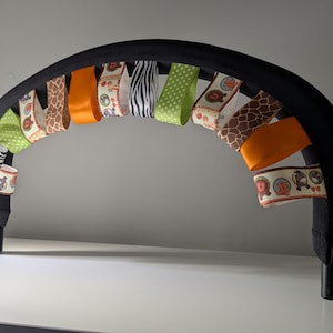 BUMPaLOOP ©2008-2025 Taggy sensory stroller bar cover Pushchair Bumper Bar Cover JUNGLE BABIES Sensory Aid with ribbon tags animal ribbon