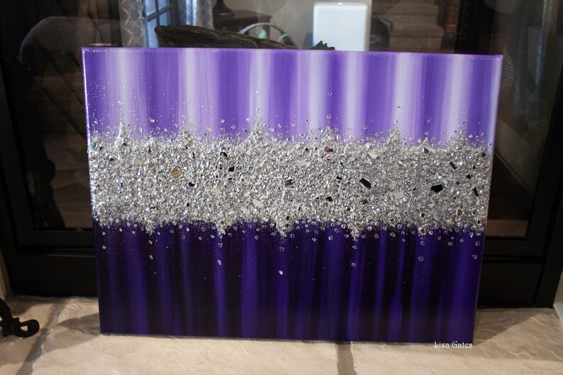 May include: Purple and silver abstract painting with a textured silver glitter layer. The painting is on a canvas and has a white border.