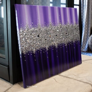 May include: Purple and silver abstract painting with a textured glitter design. The painting is on a canvas and has a white border. The artist's signature, "Lisa Gates", is in the lower right corner.