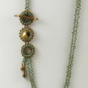 Könnte beinhalten: Eine mehrreihige Halskette mit einem goldenen und türkisfarbenen Perlenmuster. Die Halskette hat einen Anhänger mit drei runden Perlen, von denen eine golden und die anderen beiden türkisfarben sind.