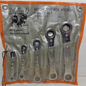 May include: A set of five Buffalo brand ratcheting box wrenches in a silver and orange packaging. The wrenches are labeled with their sizes: 1/4 x 5/16, 5/16 x 3/8, 3/8 x 7/16, 7/16 x 1/2, and 1/2 x 9/16. The packaging also includes the text "All 6 points for extra strength".