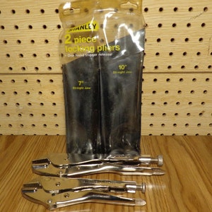 May include: Two Stanley locking pliers in a plastic package. The pliers are 7 inches and 10 inches long. The package says "2 piece locking pliers" and "One hand trigger release".