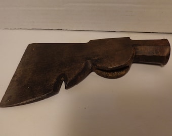 May include: A vintage, rusty, metal hammer with a claw on the back. The hammer has a wooden handle.