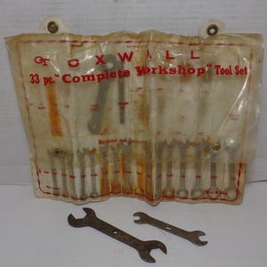 May include: A vintage clear plastic bag containing a 33 piece "Complete Workshop" tool set by Oxwall. The set includes wrenches and screwdrivers. Two wrenches are visible outside the bag.