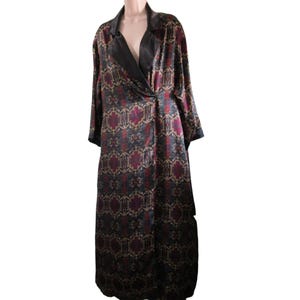 May include: A long black satin robe with a patterned design in shades of red, gold, and blue. The robe has a shawl collar and a tie closure.