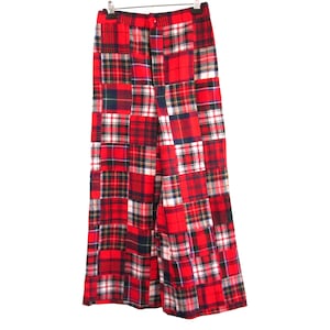 May include: Red and black tartan trousers with a patchwork design. The trousers have a straight leg and a button fly.
