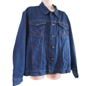 May include: A classic blue denim jacket with a button closure, two chest pockets, and a woven label on the left pocket.