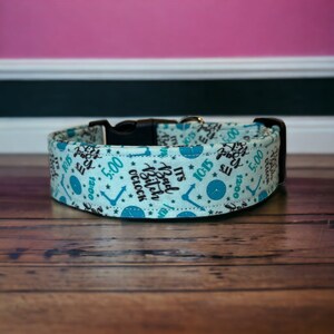 May include: A light blue dog collar with a repeating pattern of clocks and the text "It's Bad Bitch o'clock".