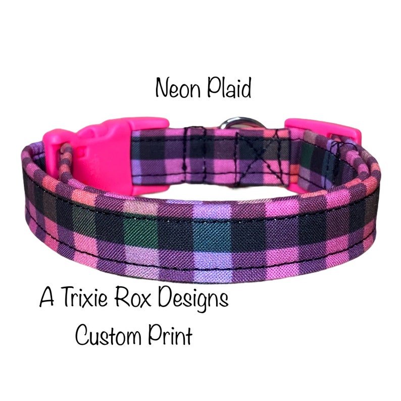 May include: A pink and black plaid dog collar with a pink plastic buckle. The collar is labeled "Neon Plaid" and "A Trixie Rox Designs Custom Print".