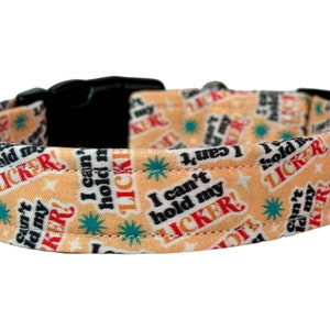 May include: A peach-colored dog collar with black text that reads "I can't hold my licker!" The collar has a black buckle.