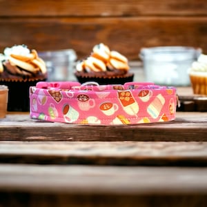 May include: Pink dog collar with a colorful pattern of coffee cups, pastries, and other sweet treats.