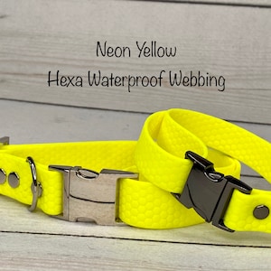 May include: Two neon yellow dog collars with silver buckles and black accents. The collars are made of waterproof webbing with a textured hexagonal pattern. The text "Neon Yellow Hexa Waterproof Webbing" is written above the collars.