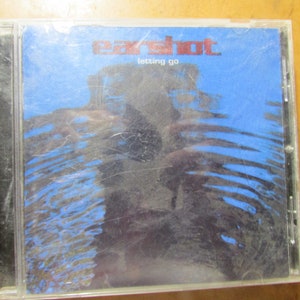 May include: A CD case with a blue cover featuring the text "earshot. letting go" in red and white. The cover has a water-like design with dark blue and black tones. The case is clear plastic.