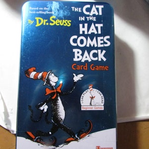 May include: A blue card game box featuring the Cat in the Hat from Dr. Seuss's "The Cat in the Hat Comes Back." The box has white text and illustrations of the character. The game is labeled as "Beginner Games."