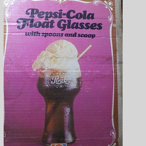 May include: A vintage Pepsi-Cola Float Glasses box with a pink background and a drawing of a float. The text reads "Pepsi-Cola Float Glasses with spoons and scoop." The Pepsi logo is at the bottom.