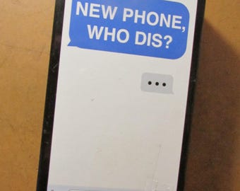 May include: A black rectangular game box with a white face featuring a phone screen design. The screen displays a blue text bubble with the words "NEW PHONE, WHO DIS?". The text "An adult party game..." and "From the creators of WHAT DO YOU MEME?" are also visible.