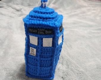 May include: A blue crocheted TARDIS, a time machine from the Doctor Who television series. The TARDIS has a white roof and the words "Police Public Call Box" on the front.