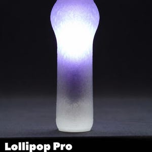 May include: A glowing, cylindrical object with a bulbous top, transitioning from white at the base to purple at the top. The text "Lollipop Pro & Lollipop Pro+" is displayed at the bottom.