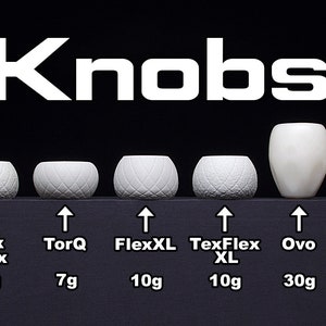 May include: Ten different white ceramic knobs with various shapes and textures. The knobs are labelled with their names and weights in grams. The names include TorQ Zorb, Sphere, Tex Flex, TorQ, FlexXL, TexFlex XL, Ovo, Pom Grip, Delphin, and PX3.