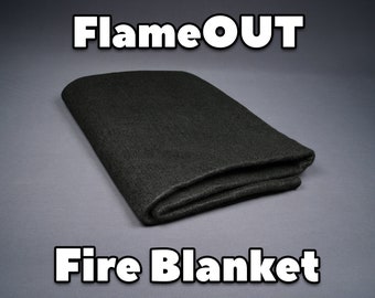 May include: A black fire blanket folded in half, with the text "FlameOUT Fire Blanket" printed below it.
