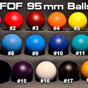 May include: Nineteen 95 mm balls in various colors, numbered 1 through 19. The balls are arranged in three rows, with six balls in the top row, six in the middle row, and seven in the bottom row.