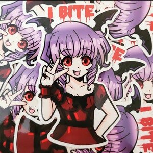May include: A sticker featuring a cartoon vampire girl with purple hair and red eyes. She is wearing a red dress and has bat wings. The sticker says "I Bite" in red dripping letters.