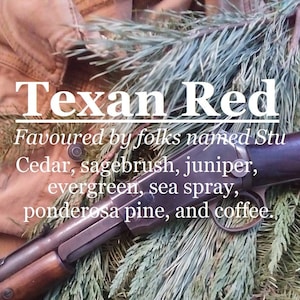 May include: A close-up of a rifle resting on a bed of green pine needles. The rifle is brown and black with a wooden stock. The text "Texan Red Favoured by folks named Stu Cedar, sagebrush, juniper, evergreen, sea spray, ponderosa pine, and coffee." is visible in the image.